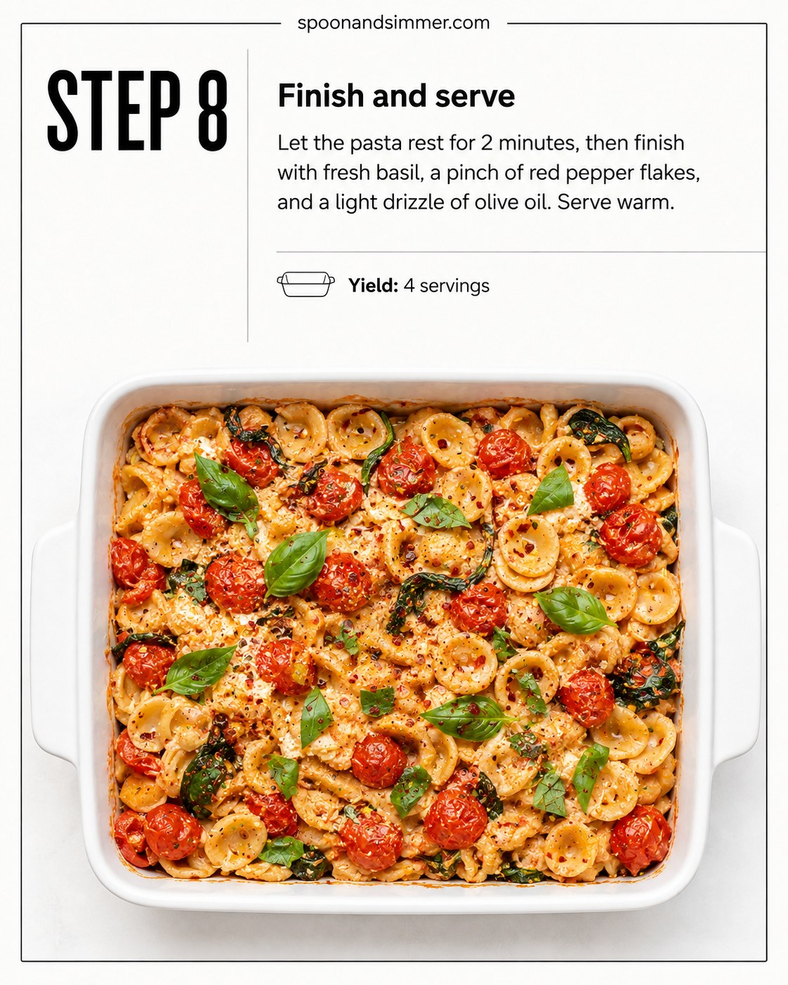 Finished baked feta pasta with spinach topped with fresh basil and chili flakes