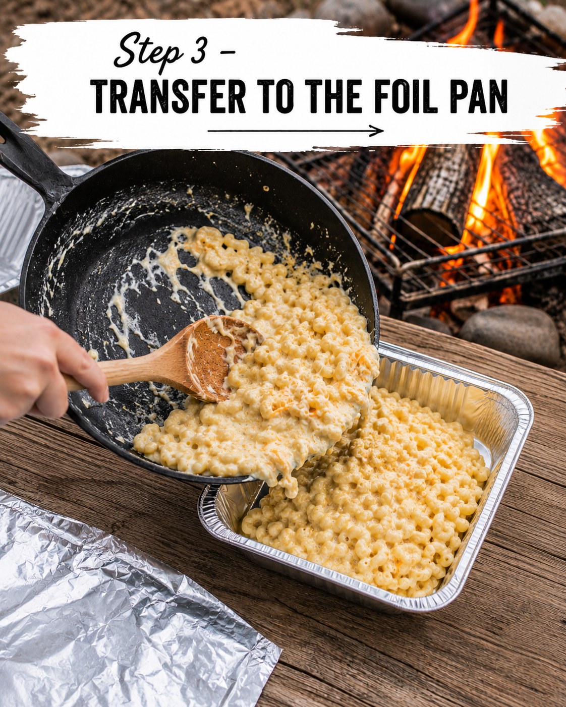 Scooping cooked campfire mac and cheese from the skillet into a disposable foil pan