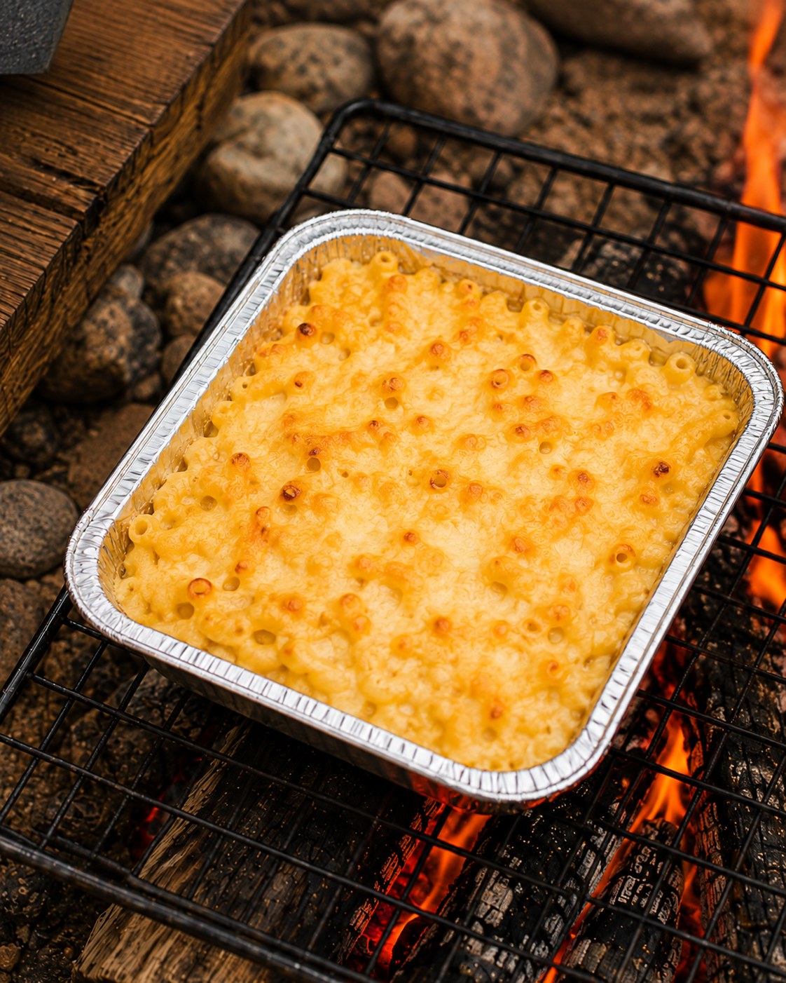 Golden, bubbly campfire mac and cheese with a browned cheese crust straight off the fire