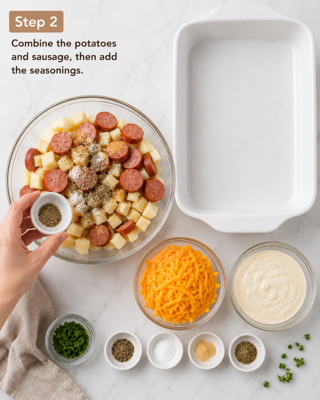 Hand seasoning diced potatoes and sausage before assembling the cheesy potato sausage casserole