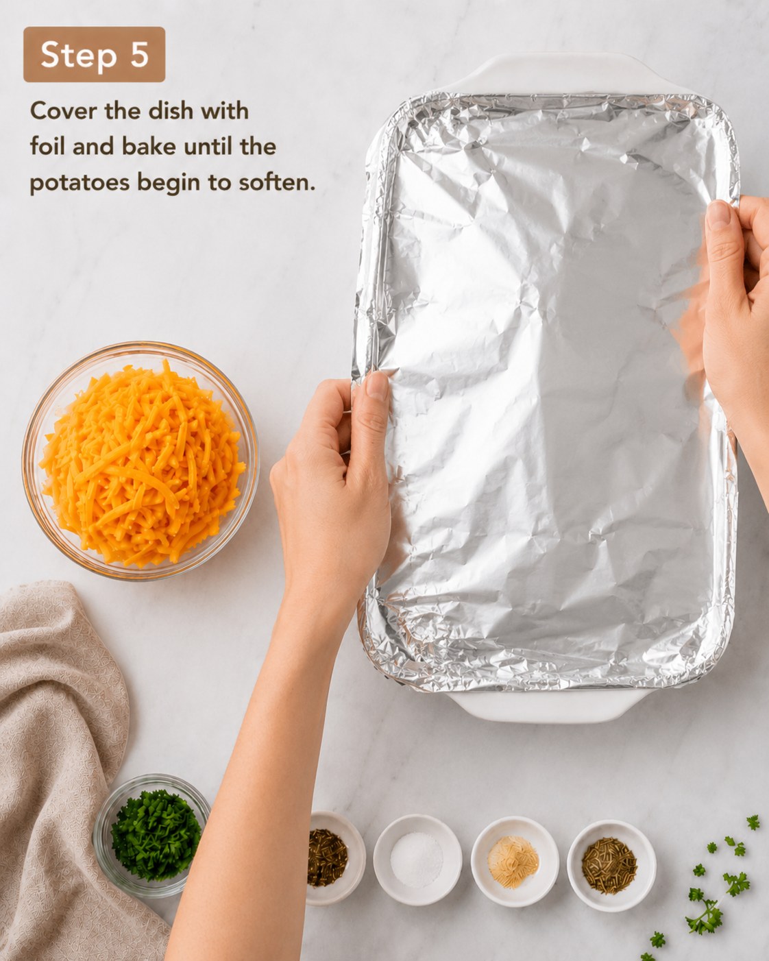Foil covering the baking dish so the cheesy potato sausage casserole steams and softens