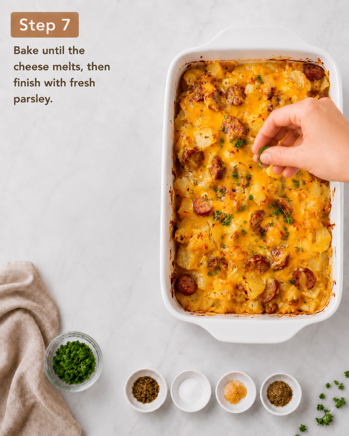 Melted cheddar and fresh parsley finishing the golden cheesy potato sausage casserole