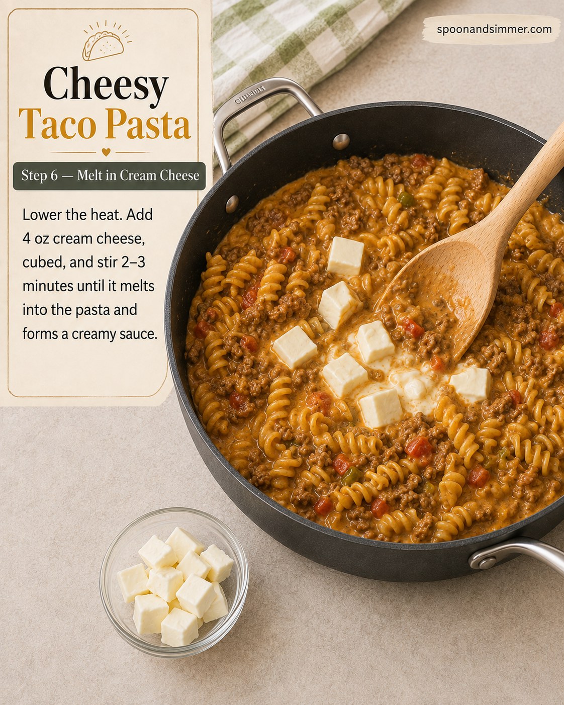 Cubed cream cheese melting into the sauce for cheesy taco pasta