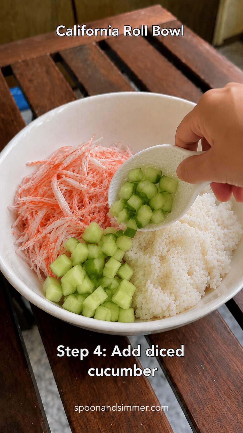 Diced cucumber being added to build an imitation crab California roll bowl