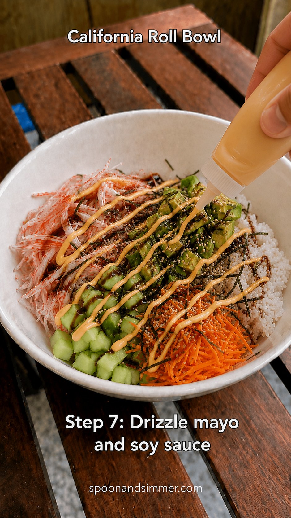 Drizzling spicy mayo and soy sauce over a finished imitation crab California roll bowl