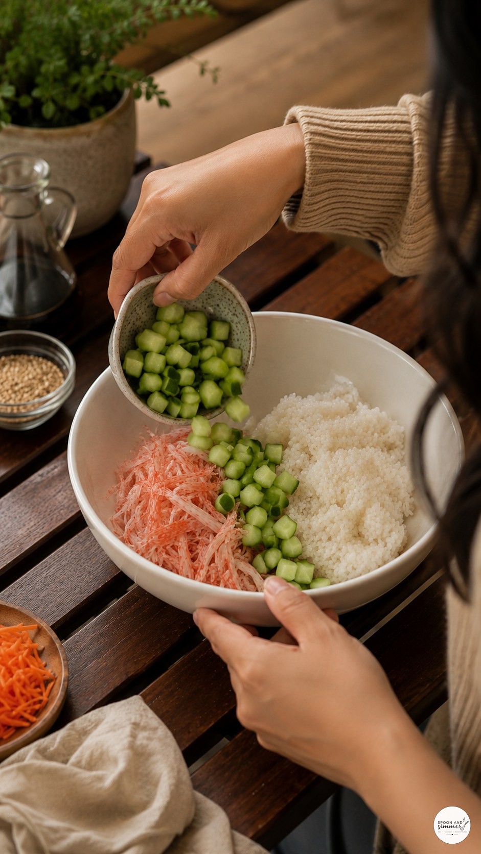 Pouring diced cucumber into a California roll bowl at an outdoor wooden table