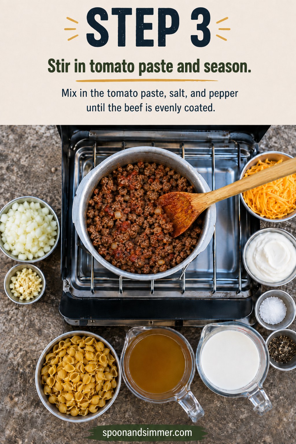 Tomato paste stirred into browned beef forming the base of camping hamburger helper on a camp stove