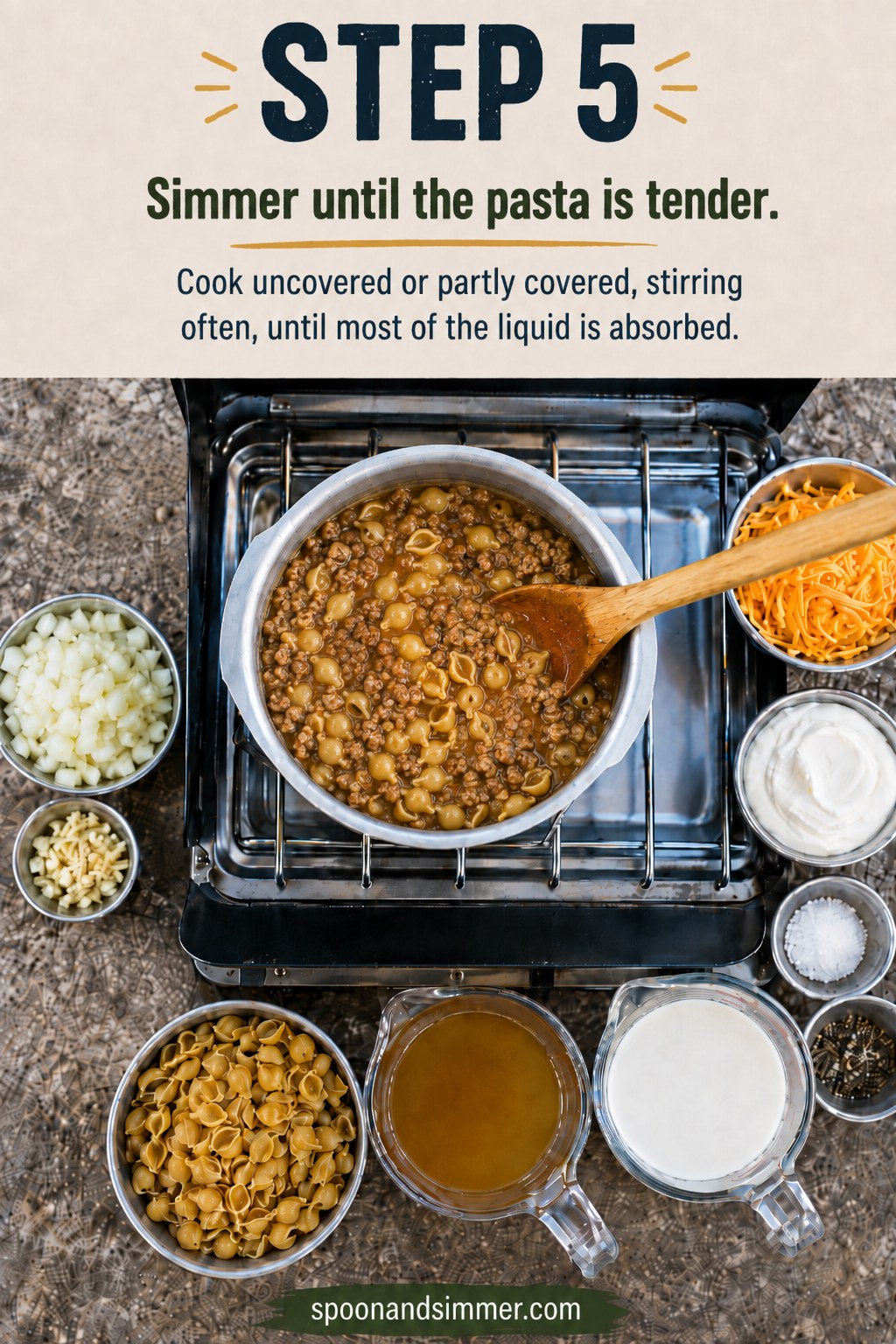One pot camping hamburger helper simmering until the pasta shells turn tender