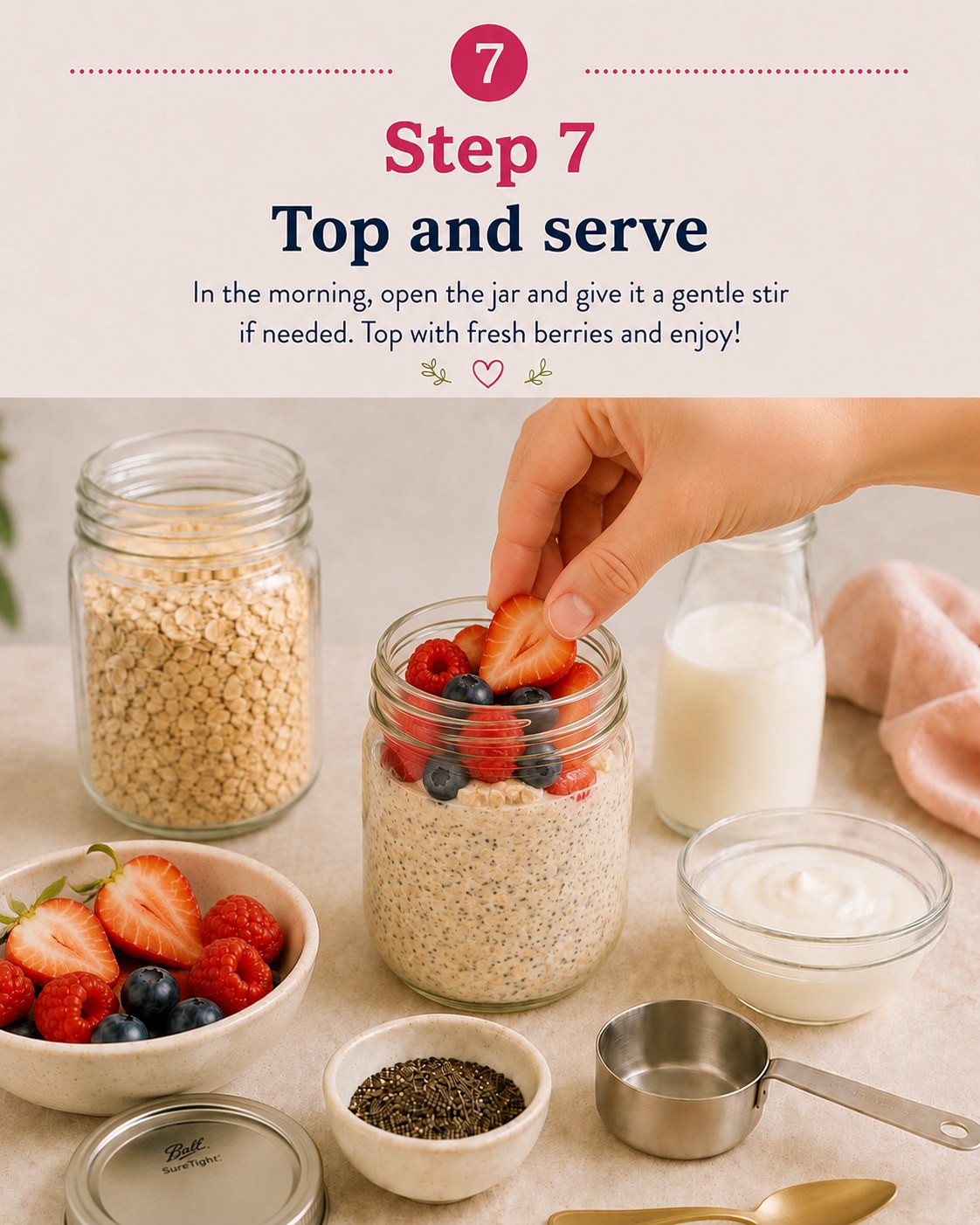 Adding a fresh strawberry to a chilled overnight oats jar topped with berries in the morning