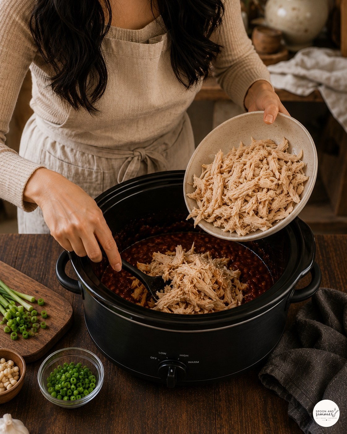 Returning shredded chicken to the thickened honey garlic sauce in the slow cooker